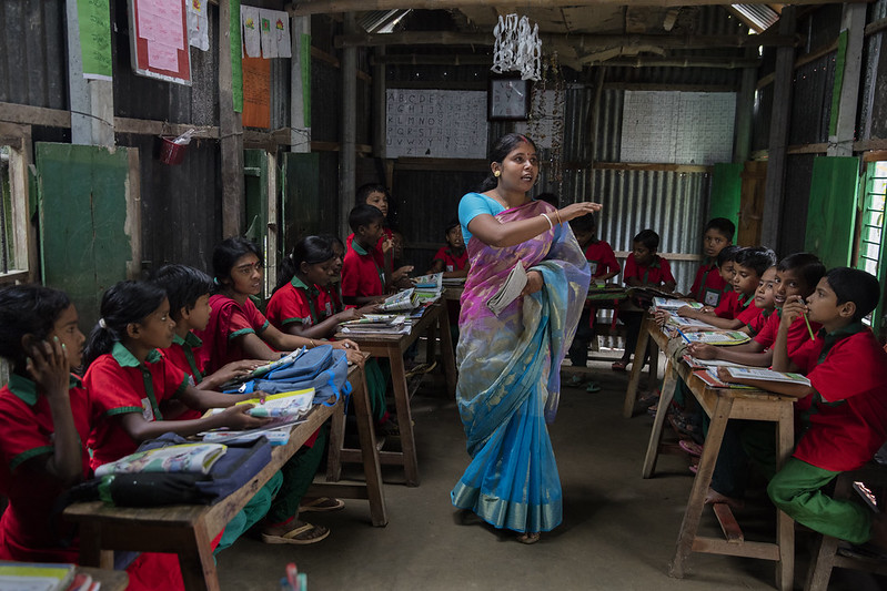 Students listen to their school teacher, Shuma Das during class at the Sahabatpur Daspara Ananda school in Sahabatpur village, Bangladesh