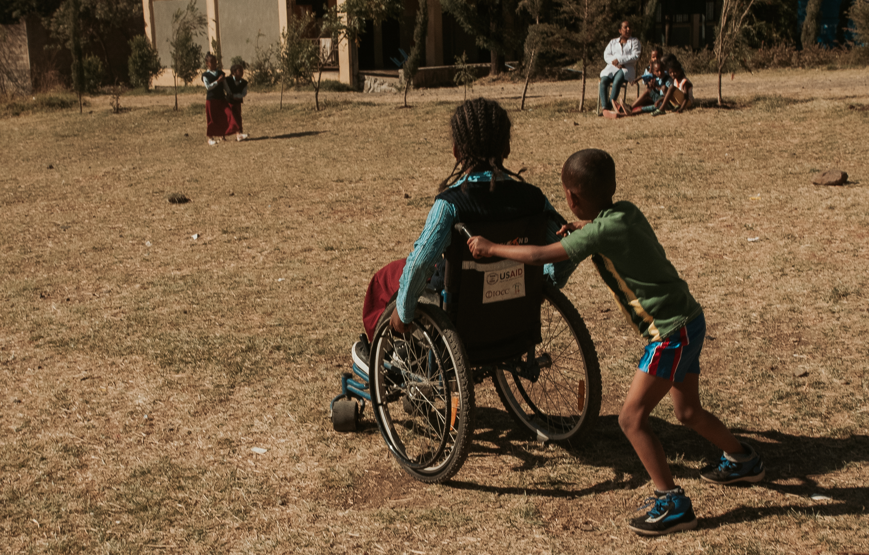 One student pushes his classmate in a wheelchair in the school yard at the Menelik II Primary School in Addis Ababa. 