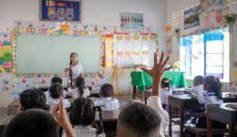 Students raise their hands during a class in Chambak Haer Primary School, Puok District in Siem Reap, Cambodia.