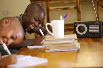 Kevin, 11, listens to radio lessons at home while his primary school is closed