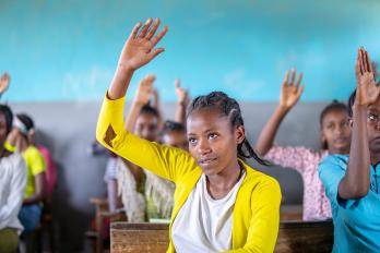A student lifts their hand in class.
