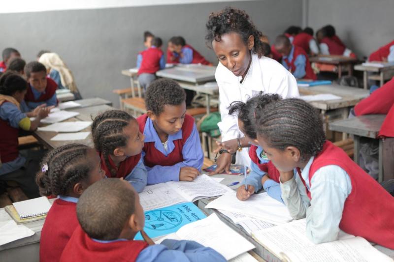 A teacher helping a group of students during a class at Hidassie School in Addis Ababa, Ethiopia. November 2013.